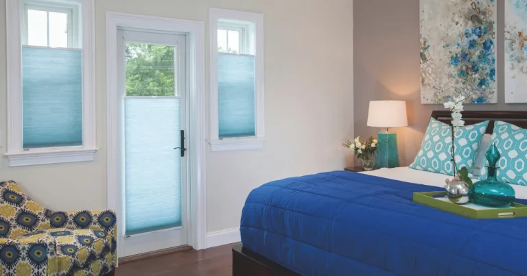 Honeycomb Shades A Bedroom With Blue Accents, Cellular Shades, And Artwork