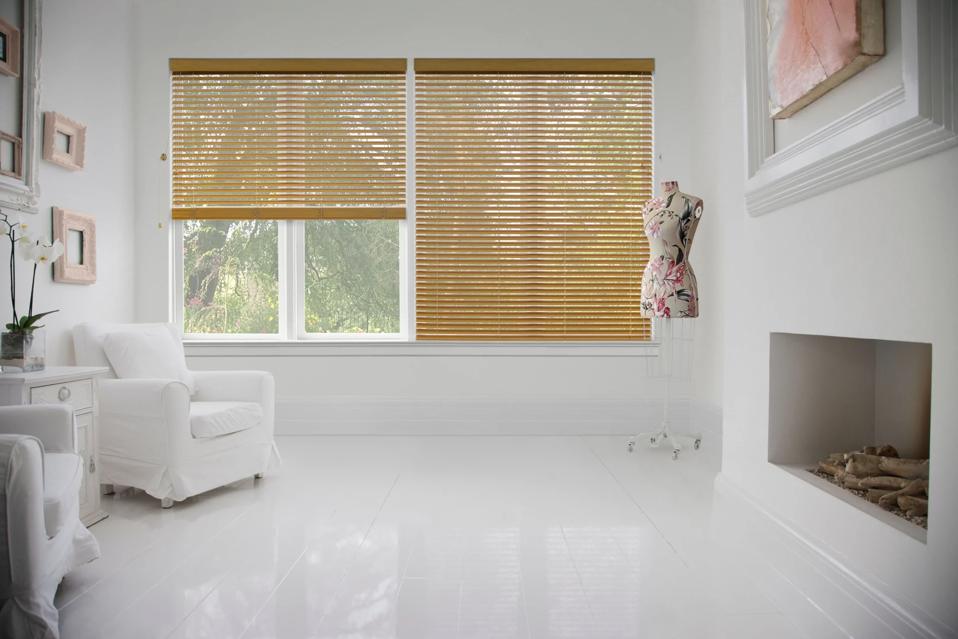 Woodnature Venetians A Bright, White Room With Large Windows Covered By Light Brown Blinds, Features White Furniture And A Decorative Mannequin